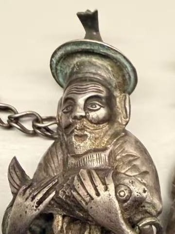 Detail: the fisherman’s face and the carp in his hands